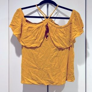 Off the shoulder top with spaghetti straps by the neck.